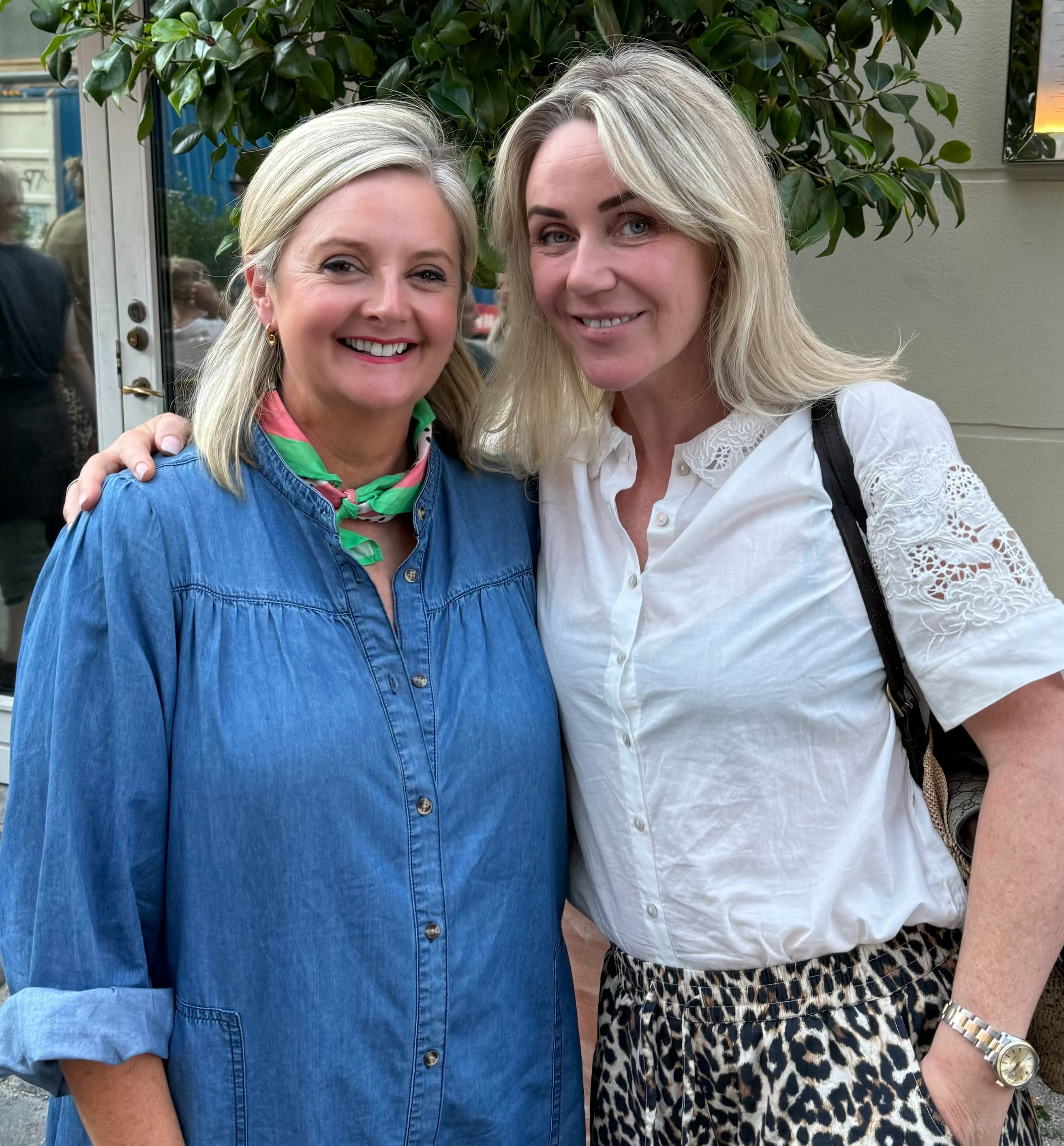 Two women standing together outdoors, smiling at the camera wearing Lollys Laundry